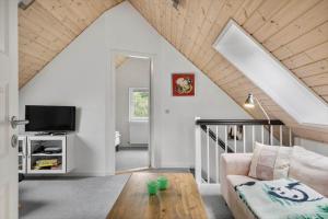 a living room with a couch and a tv at 80057-Ulfborg-Rolighedsvej-3 in Ulfborg