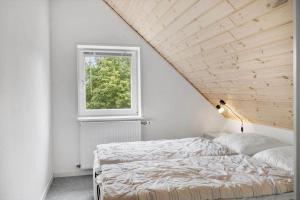a bedroom with a bed and a window at 80057-Ulfborg-Rolighedsvej-3 in Ulfborg