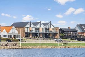 a large house on the shore of a body of water at 70774-Ulfborg-Skolegade-15-Lejl-5 in Ulfborg