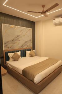 a bedroom with a large bed with a ceiling at Hotel Krishna Residency in Udaipur
