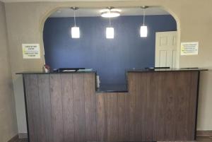 a counter in a room with a blue wall at Super 8 by Wyndham Florence in Florence