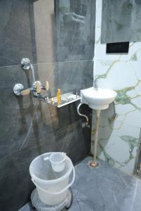 a bathroom with a toilet and a sink at Hotel Krishna Residency in Udaipur +35 photos