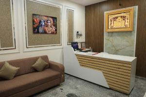 a office with a couch and a painting on the wall at Hotel Krishna Residency in Udaipur