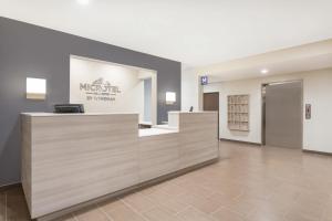 a lobby of a maseru salon with a reception desk at Microtel Inn & Suites by Wyndham Springville in Springville +38 photos