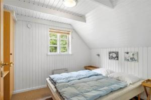 a bedroom with a large bed in a attic at 10616-Ulfborg-Vester-Mosevej-28 in Ulfborg