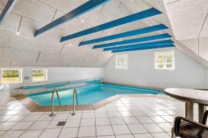 a swimming pool with blue ceilings in a room at 10616-Ulfborg-Vester-Mosevej-28 in Ulfborg