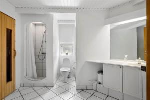 a white bathroom with a shower and a toilet at 10616-Ulfborg-Vester-Mosevej-28 in Ulfborg +16 photos