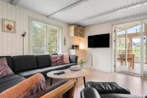 a living room with a couch and a table at 30185-Ulfborg-Bellisvej-509 in Ulfborg