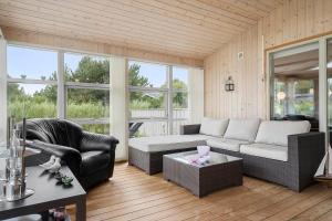 a living room with a couch and a table at 30185-Ulfborg-Bellisvej-509 in Ulfborg