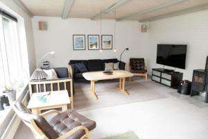 a living room with a couch and a table at 10294-Ulfborg-Gaffelbjergvej-44 in Ulfborg +19 photos