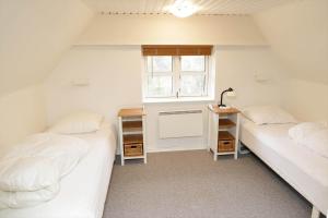 two twin beds in a room with a window at 10294-Ulfborg-Gaffelbjergvej-44 in Ulfborg