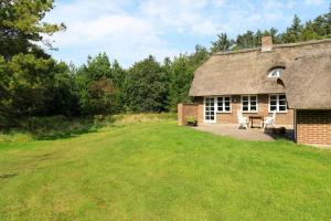 a brick house with a grass yard in front of it at 10294-Ulfborg-Gaffelbjergvej-44 in Ulfborg