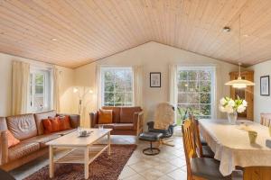 a living room with a couch and a table at 30848-Ulfborg-Valmuevej-286 in Ulfborg