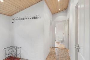 a bathroom with a white wall and a toilet at 30848-Ulfborg-Valmuevej-286 in Ulfborg +20 photos