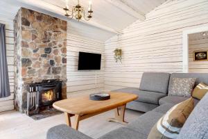 a living room with a couch and a fireplace at 80182-Vemb-Ogelstrupvej-4 in Vemb