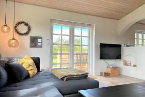 a living room with a couch and a tv at 20708-Ulfborg-Sortebaervej-6 in Ulfborg