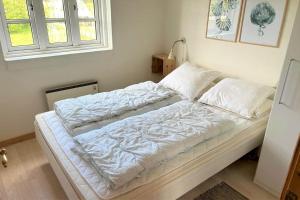 an unmade bed in a room with a window at 20708-Ulfborg-Sortebaervej-6 in Ulfborg