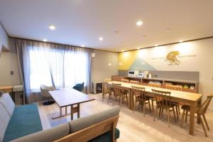 a living room with a table and chairs at B cycle Double Room in Biei