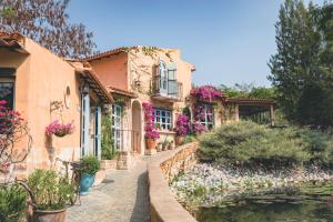 a house with flowers on the side of a street at Moon River Village in Ban Bu Khanun