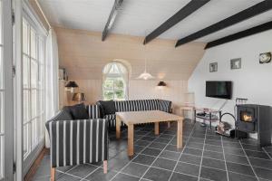a living room with a couch and a table at 20220-Ulfborg-Sundhuse-13 in Ulfborg