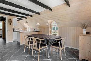 a kitchen and dining room with a table and chairs at 20220-Ulfborg-Sundhuse-13 in Ulfborg +15 photos