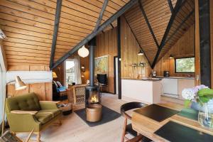 a living room with a fireplace in a house at 80179-Vemb-Harpotvej-74 in Vemb