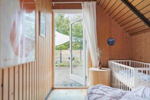 a bedroom with a bed and a sliding glass door at 80179-Vemb-Harpotvej-74 in Vemb