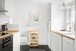 a white kitchen with white cabinets and a sink at 10808-Ulfborg-Vester-Mosevej-84 in Ulfborg +13 photos