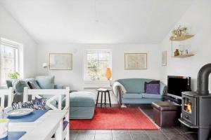 a living room with a couch and a stove at 10808-Ulfborg-Vester-Mosevej-84 in Ulfborg