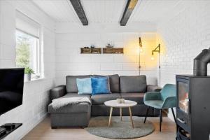 a living room with a couch and a table at 20041-Ulfborg-Knakvej-10 in Ulfborg