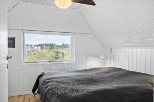 a bedroom with a bed and a window at 20041-Ulfborg-Knakvej-10 in Ulfborg
