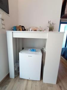 a white desk with a trash can under it at Rooms of Nectar in Poros +30 photos