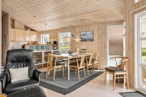 a kitchen and dining room with a table and chairs at 30872-Ulfborg-Bellisvej-514 in Ulfborg