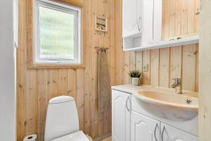 a bathroom with a white toilet and a sink at 30872-Ulfborg-Bellisvej-514 in Ulfborg +20 photos