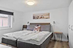 a large bed in a room with white walls at 70181-Ulfborg-Enghavevej-2 in Ulfborg