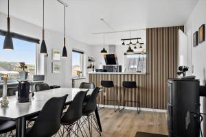 a kitchen and dining room with a table and chairs at 70181-Ulfborg-Enghavevej-2 in Ulfborg