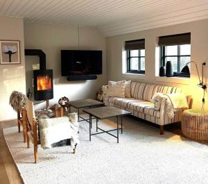 a living room with a couch and a fire place at 10735-Ulfborg-Graevlingevej-11 in Ulfborg