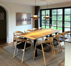 a dining room with a wooden table and chairs at 10735-Ulfborg-Graevlingevej-11 in Ulfborg +12 photos