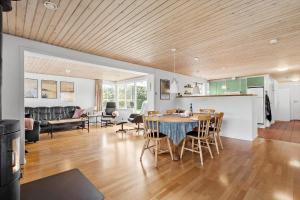 a kitchen and living room with a table and chairs at 30789-Ulfborg-Akelejevej-276 in Ulfborg