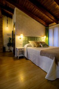 a bedroom with a white bed with lights on it at Refugi dels Somnis - Turismo con encanto en Onda in Onda