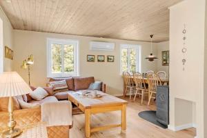a living room with a couch and a table at 10718-Ulfborg-Baekbyvej-117 in Ulfborg