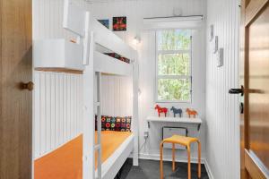 a childs room with a bunk bed and a window at 80262-Vemb-Hyttevej-103 in Vemb