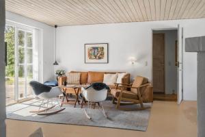 a living room with a couch and chairs and a table at 10611-Ulfborg-Gaffelbjergvej-6 in Ulfborg