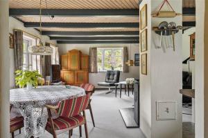 a living room with a dining room table and chairs at 10755-Ulfborg-Kjaergaardvej-20 in Ulfborg