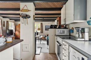 a kitchen with white appliances and a dining room at 10755-Ulfborg-Kjaergaardvej-20 in Ulfborg +13 photos