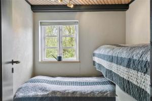 a bedroom with a bed and a window at 10755-Ulfborg-Kjaergaardvej-20 in Ulfborg