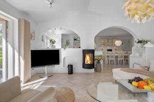 a living room with a tv and a fireplace at 10833-Ulfborg-Graemvej-19 in Ulfborg