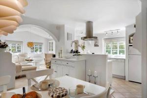 a kitchen and living room with a table and a counter at 10833-Ulfborg-Graemvej-19 in Ulfborg