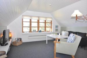 a living room with a couch and a table at 20038-Ulfborg-Knakvej-8 in Ulfborg
