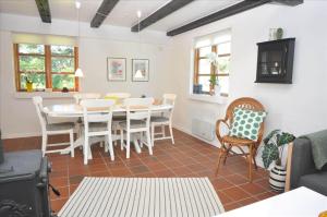 a dining room with a white table and chairs at 20038-Ulfborg-Knakvej-8 in Ulfborg